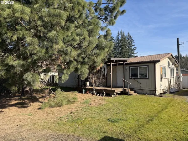 a view of a house with a yard covered in snow