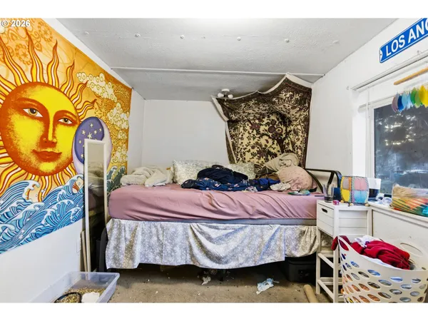 a bedroom with a bed and dresser