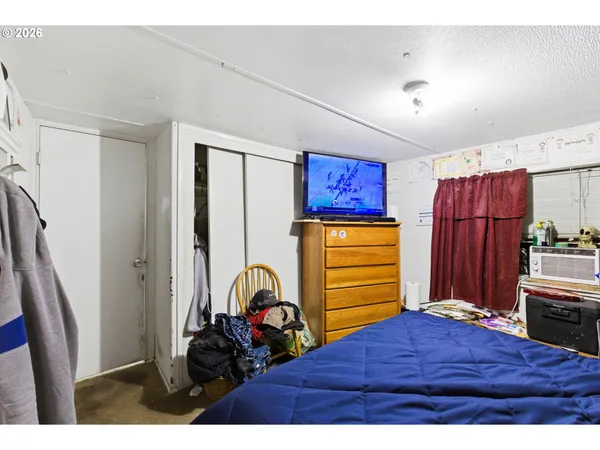 a bedroom with a bed and a mirror