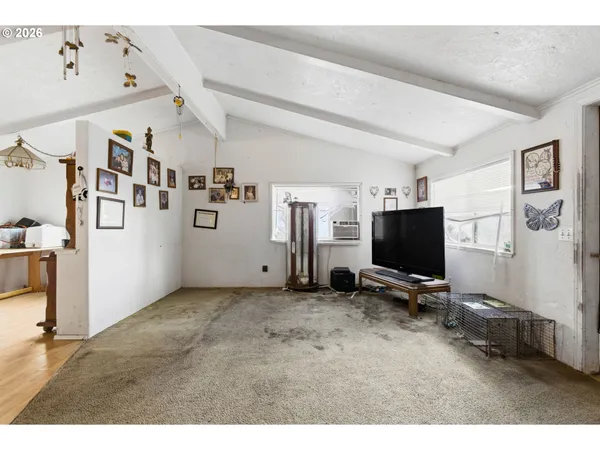 a view of a livingroom with furniture and a flat screen tv