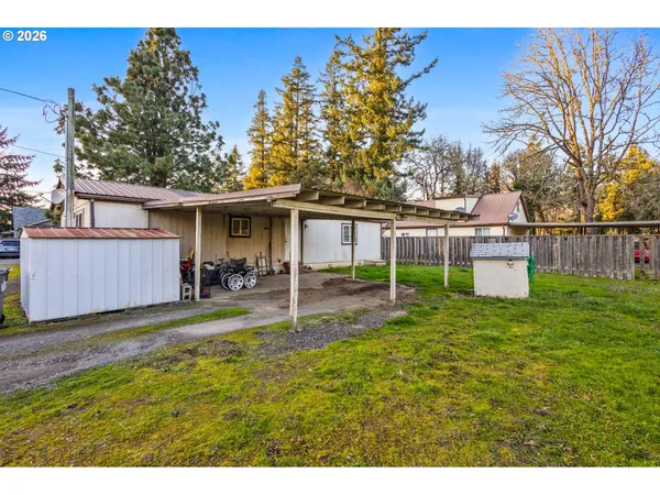 a view of a house with backyard and sitting area