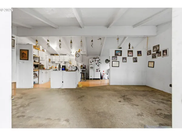a view of kitchen with refrigerator and cabinets
