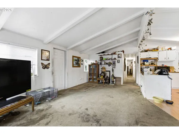 a view of a livingroom with furniture and a flat screen tv