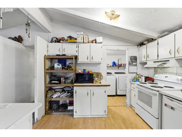 a kitchen with refrigerator and cabinets