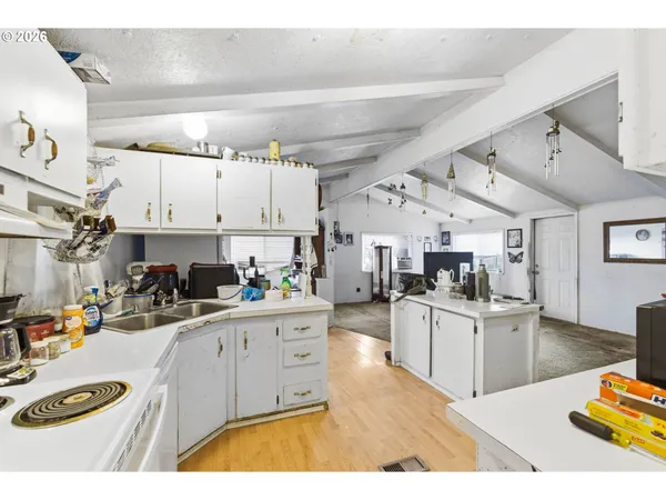 a kitchen with stainless steel appliances kitchen island granite countertop a sink and cabinets