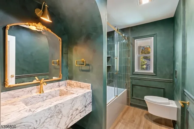 a bathroom with a sink a toilet a tub and shower