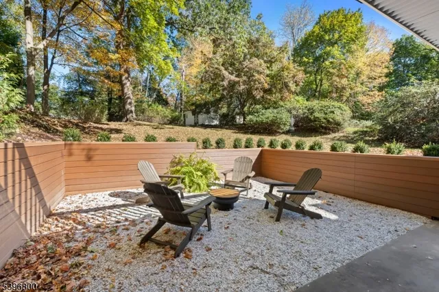 a view of a lounge chair in the middle of a yard