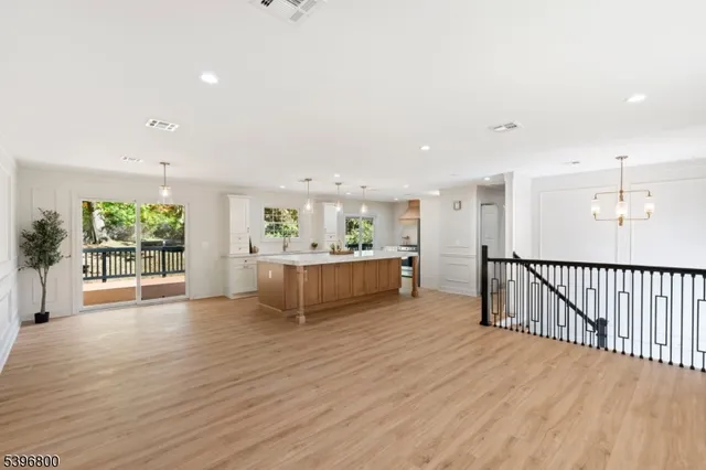 a view of a big room with wooden floor and windows