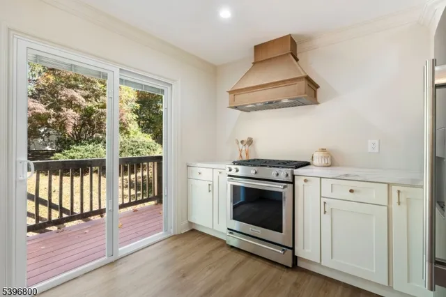 a kitchen with a stove and a wooden floor