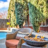 a view of a backyard with fountain table and chairs