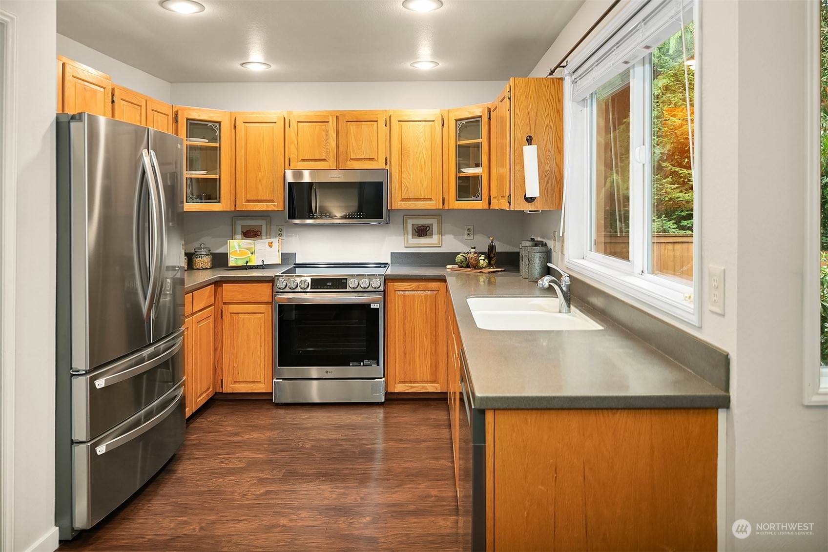 23122 20th Avenue Southeast Bothell, WA 98021 - Photo 13 of 35 a kitchen with stainless steel appliances granite countertop a refrigerator a stove top oven a sink and dishwasher