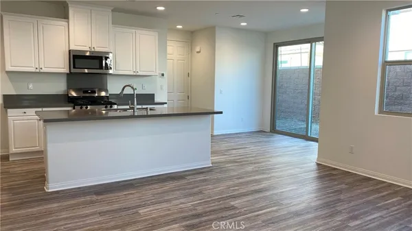a kitchen with stainless steel appliances granite countertop a sink a stove and a refrigerator