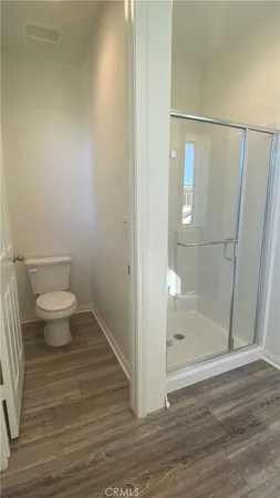 a bathroom with a toilet and a shower