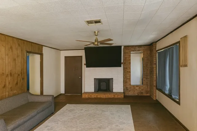 a living room with a fireplace furniture and a rug