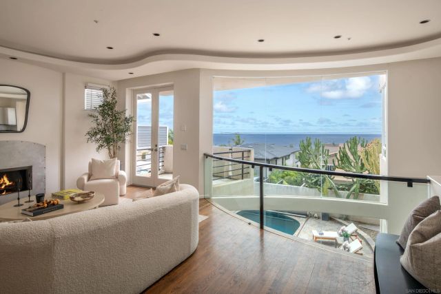 a living room with stainless steel appliances furniture and a large window