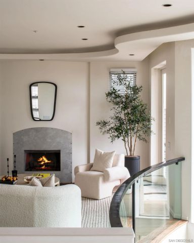 a living room with furniture and large windows