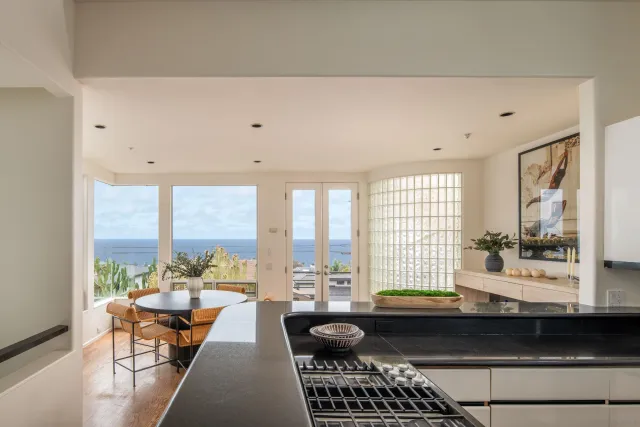 a kitchen with granite countertop a sink a stove and cabinets