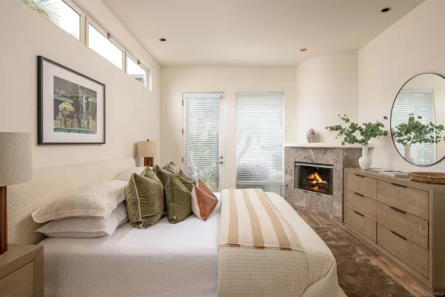 a bedroom with a bed and a fireplace