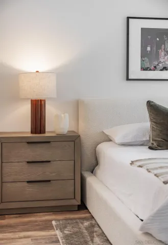 a bathroom with a granite countertop tub sink and mirror