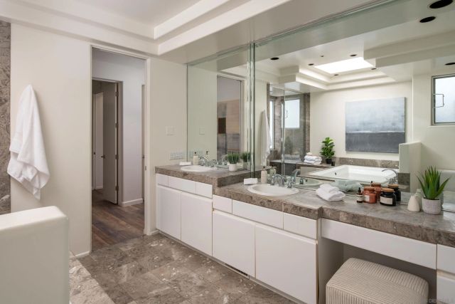 a room with painting on the table and a potted plant