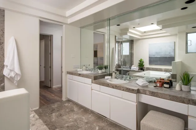 a room with painting on the table and a potted plant