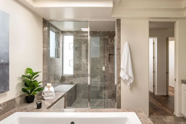 a view of a balcony with two chairs and a potted plant