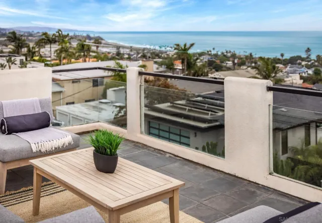 a view of a hallway with wooden floor and a living room