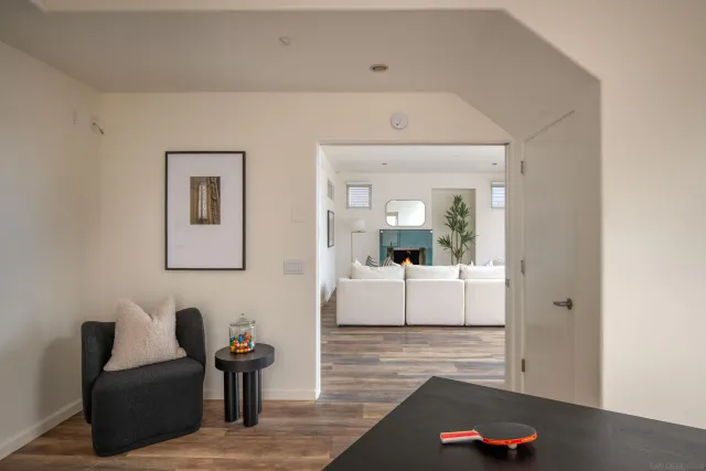 a living room with furniture and a view of kitchen