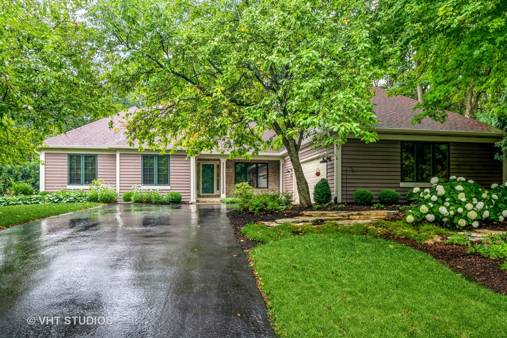 a front view of a house with a garden