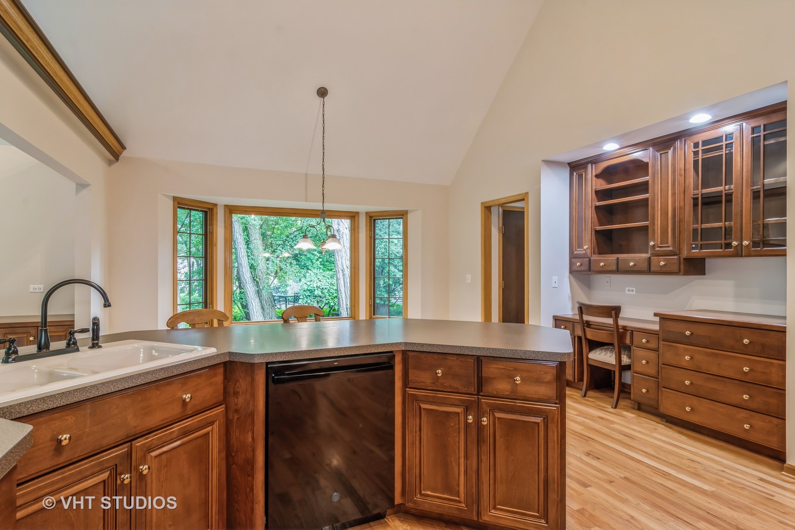 980 Pinecrest Drive Sugar Grove, IL 60554 - Photo 7 of 38 a kitchen with granite countertop wooden cabinets a dining table and chairs