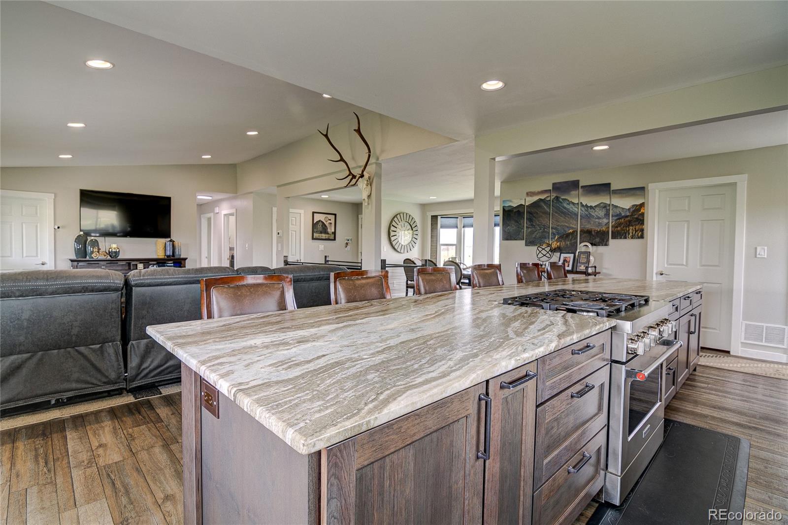 4531 East Best Road Larkspur, CO 80118 - Photo 7 of 49 a kitchen with granite countertop a sink a counter top space stainless steel appliances and cabinets