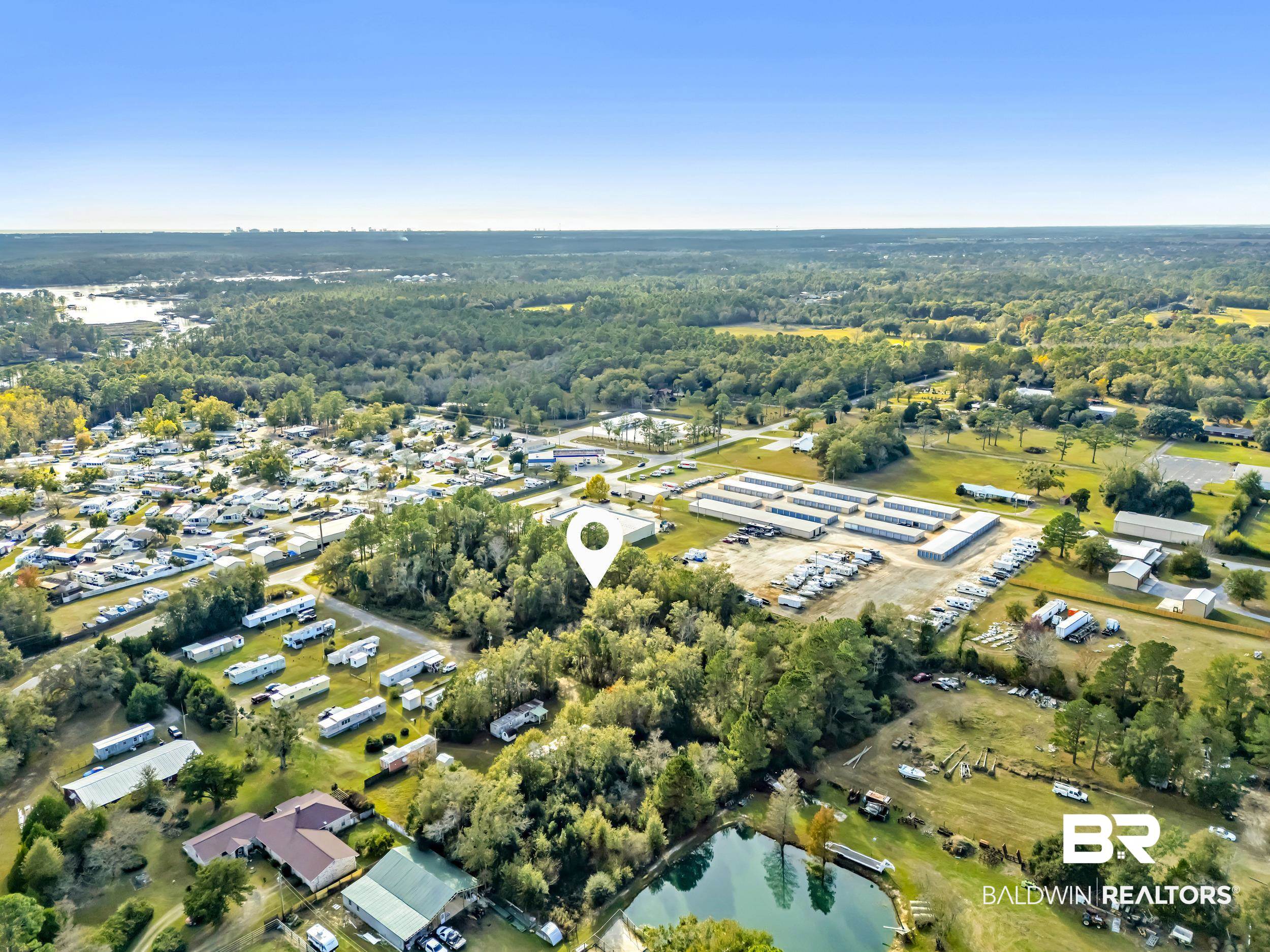 9967 County Road 83 Elberta, AL 36530 - Photo 12 of 21 Aerial view of property and surrounding area featuring a large body of water and a forest
