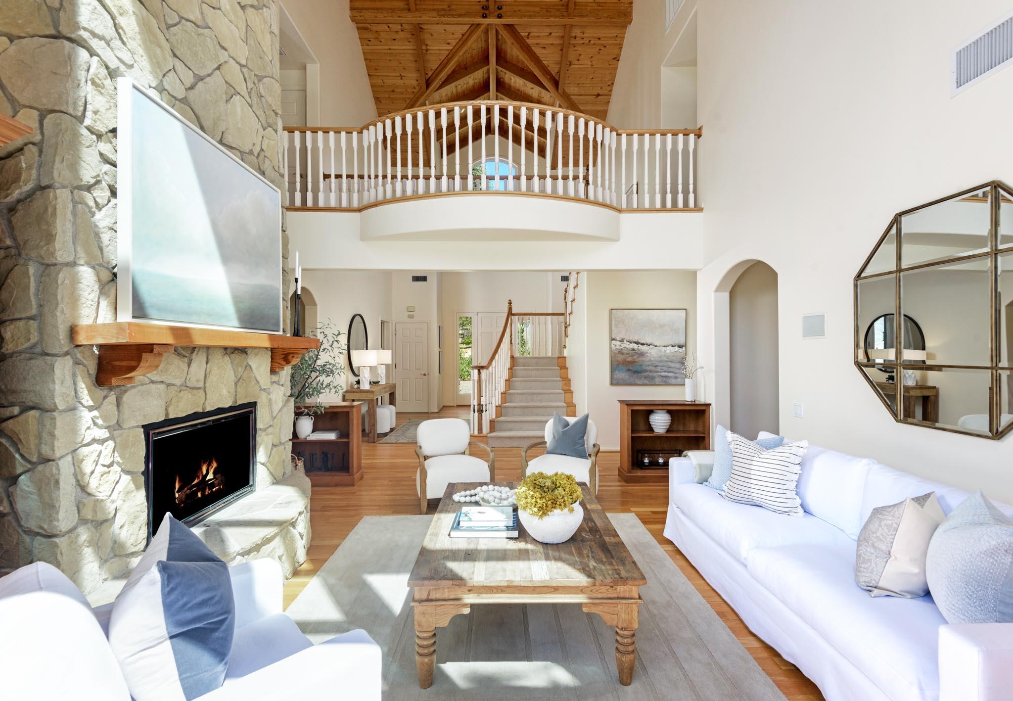 1444 Tunnel Road Santa Barbara, CA 93105 - Photo 16 of 24 a living room with furniture a fireplace and a floor to ceiling window