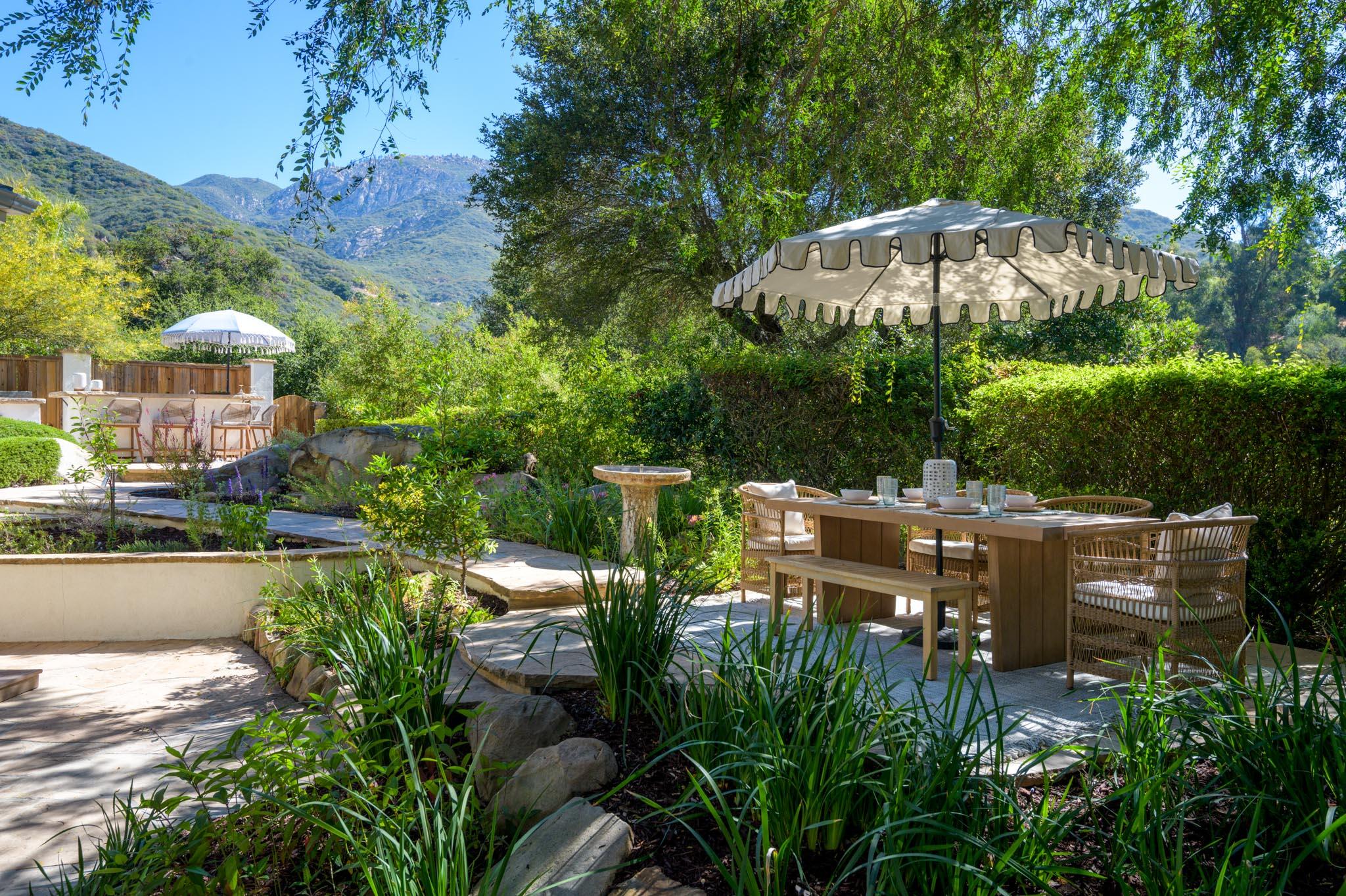 1444 Tunnel Road Santa Barbara, CA 93105 - Photo 18 of 24 a view of a patio with table and chairs under an umbrella