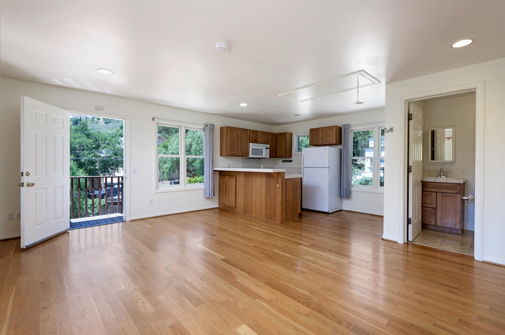 1444 Tunnel Road Santa Barbara, CA 93105 - Photo 23 of 24 an empty room with wooden floor and windows
