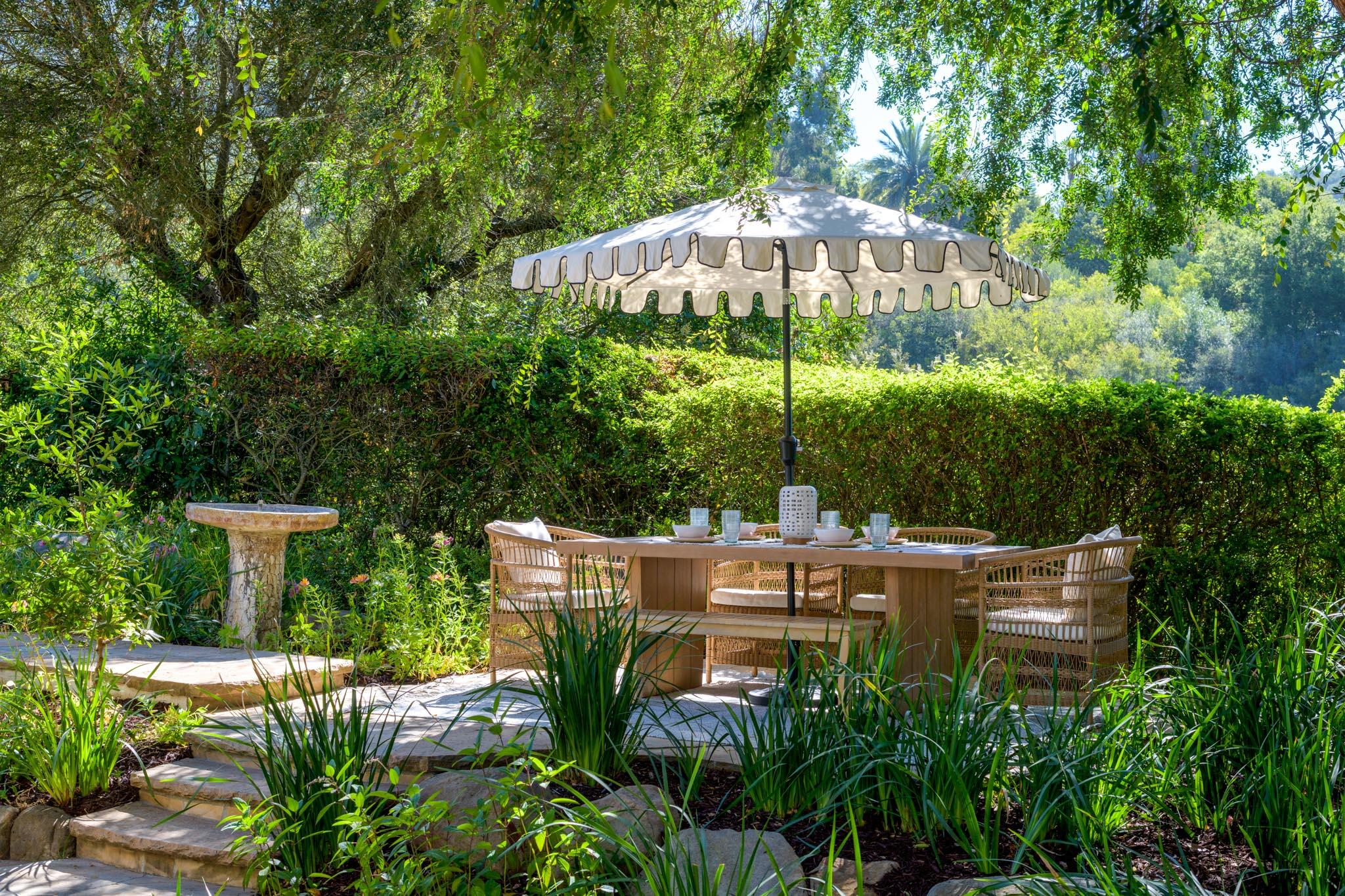 1444 Tunnel Road Santa Barbara, CA 93105 - Photo 3 of 24 a backyard of a house with table and chairs under an umbrella