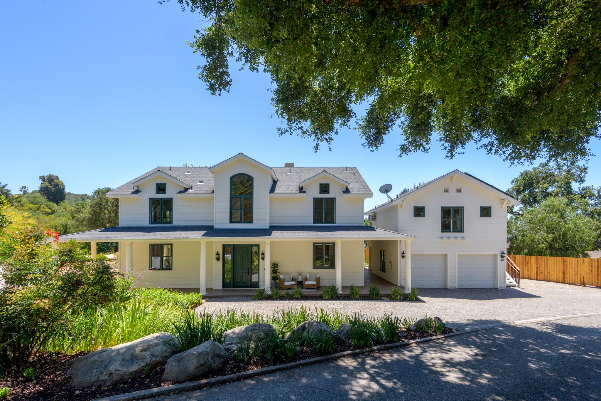 1444 Tunnel Road Santa Barbara, CA 93105 - Photo 6 of 24 a front view of a house with a yard and garage