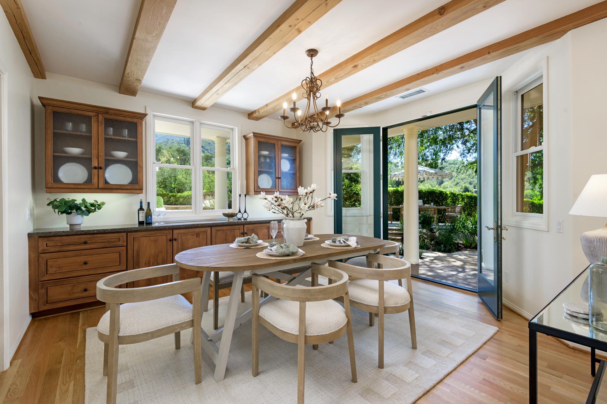1444 Tunnel Road Santa Barbara, CA 93105 - Photo 9 of 24 a dining room with furniture a chandelier and wooden floor