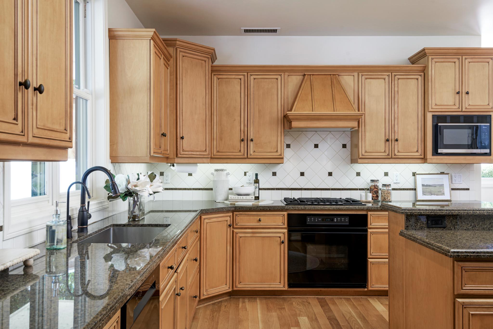 1444 Tunnel Road Santa Barbara, CA 93105 - Photo 10 of 24 a kitchen with granite countertop a sink stainless steel appliances and cabinets