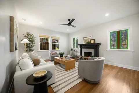 a living room with furniture a fireplace and a flat screen tv