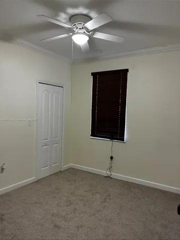 a view of an empty room with a fan