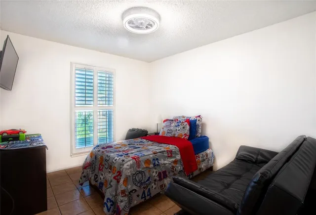a bed sitting in a bedroom next to a window