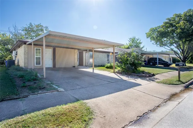 a front view of a house with yard and tress