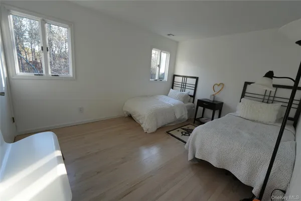 a bedroom with two beds and a window