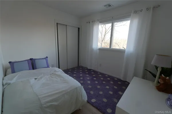 a bedroom with a bed and a lamp