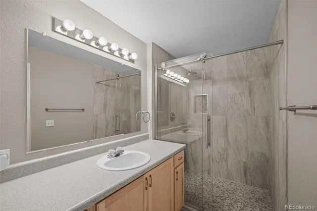 a bedroom with a bed and a potted plant next to a window