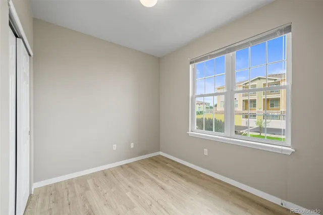 a view of an empty room with wooden floor