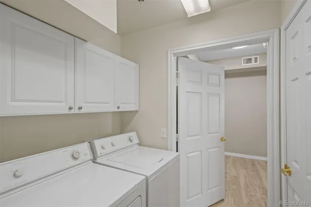 a view of storage and utility room with washer and dryer
