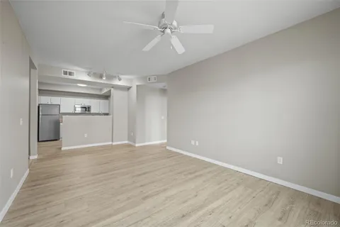wooden floor in an empty room with a kitchen