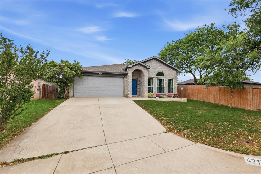 4217 Broken Arrow Road Fort Worth, TX 76137 - Photo 3 of 40 a front view of a house with a yard and garage